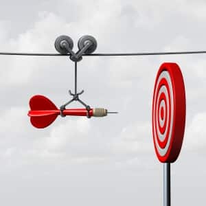 Success hitting target as a business assistance concept with the help of a guide as a symbol for goal achievement management and aim to hit the bull's eye as a dart assured to go straight towards the center.