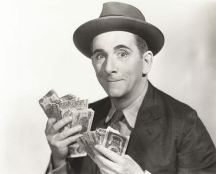 man with dollar bills in his hands